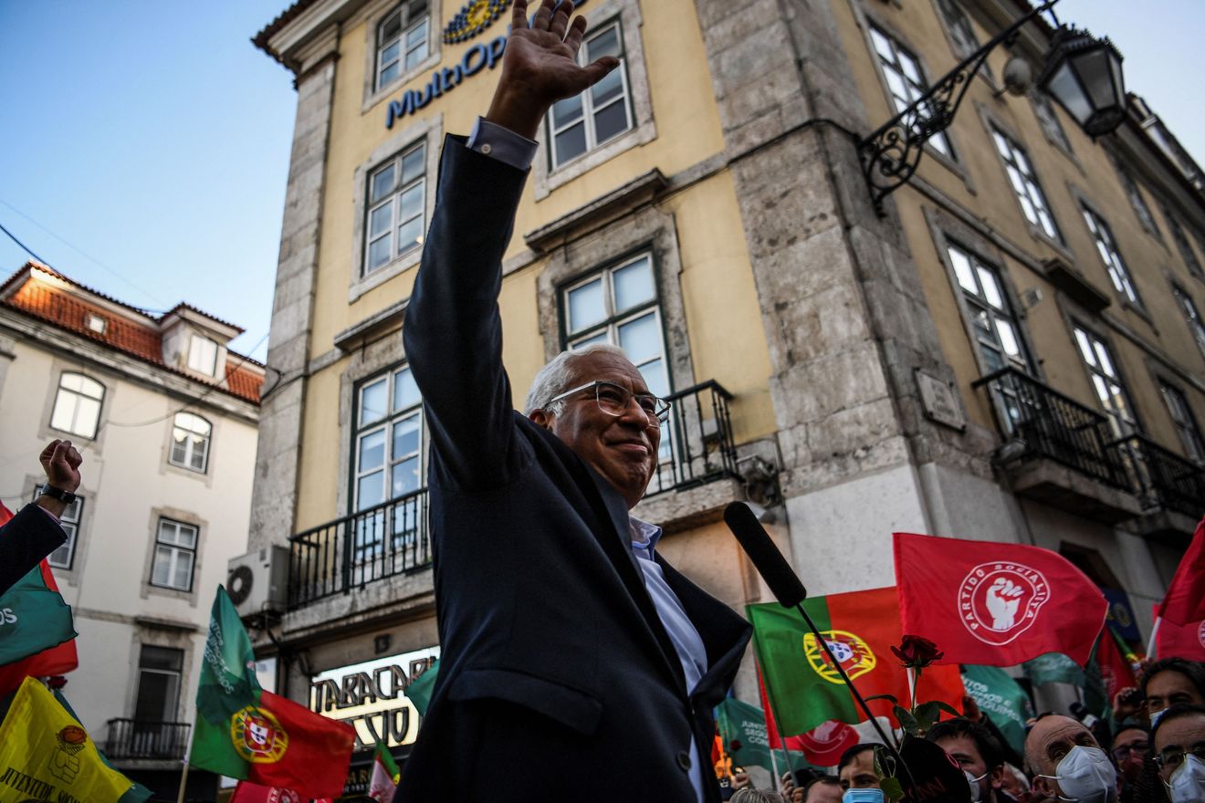 Members of the Portuguese Communist Party Youth carry flags and